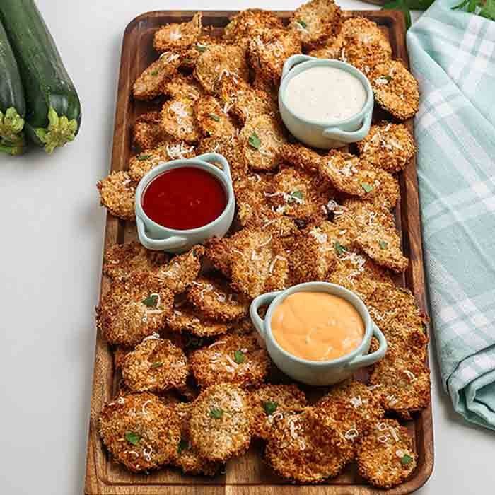 Craving a crispy and salty snack? Try making easy Air fryer zucchini chips for a healthy snack idea that even the kids will enjoy.  The entire family will enjoy breaded air fryer parmesan zucchini chips. Learn how to make easy air fryer healthy snacks. If you are eating low carb, air fryer zucchini chips low carb is a great snack idea. #eatingonadime #airfryerzucchinichips #airfryer #airfryerzucchinichipsparmesan #parmesanzucchinichipsinairfryer #airfryerzucchinichipspanko #airfried