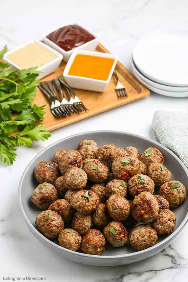 Air fryer meatballs recipe takes all of the work out of making homemade meatballs. In minutes, your family can enjoy the best flavor packed meatballs. Enjoy this easy beef and turkey recipe on subs, spaghetti and more. #eatingonadime #airfryermeatballs