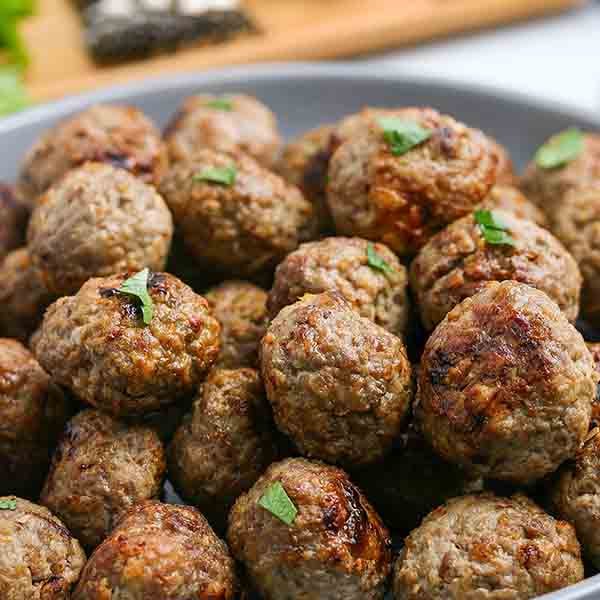 Air fryer meatballs recipe takes all of the work out of making homemade meatballs. In minutes, your family can enjoy the best flavor packed meatballs. Enjoy this easy beef and turkey recipe on subs, spaghetti and more. #eatingonadime #airfryermeatballs