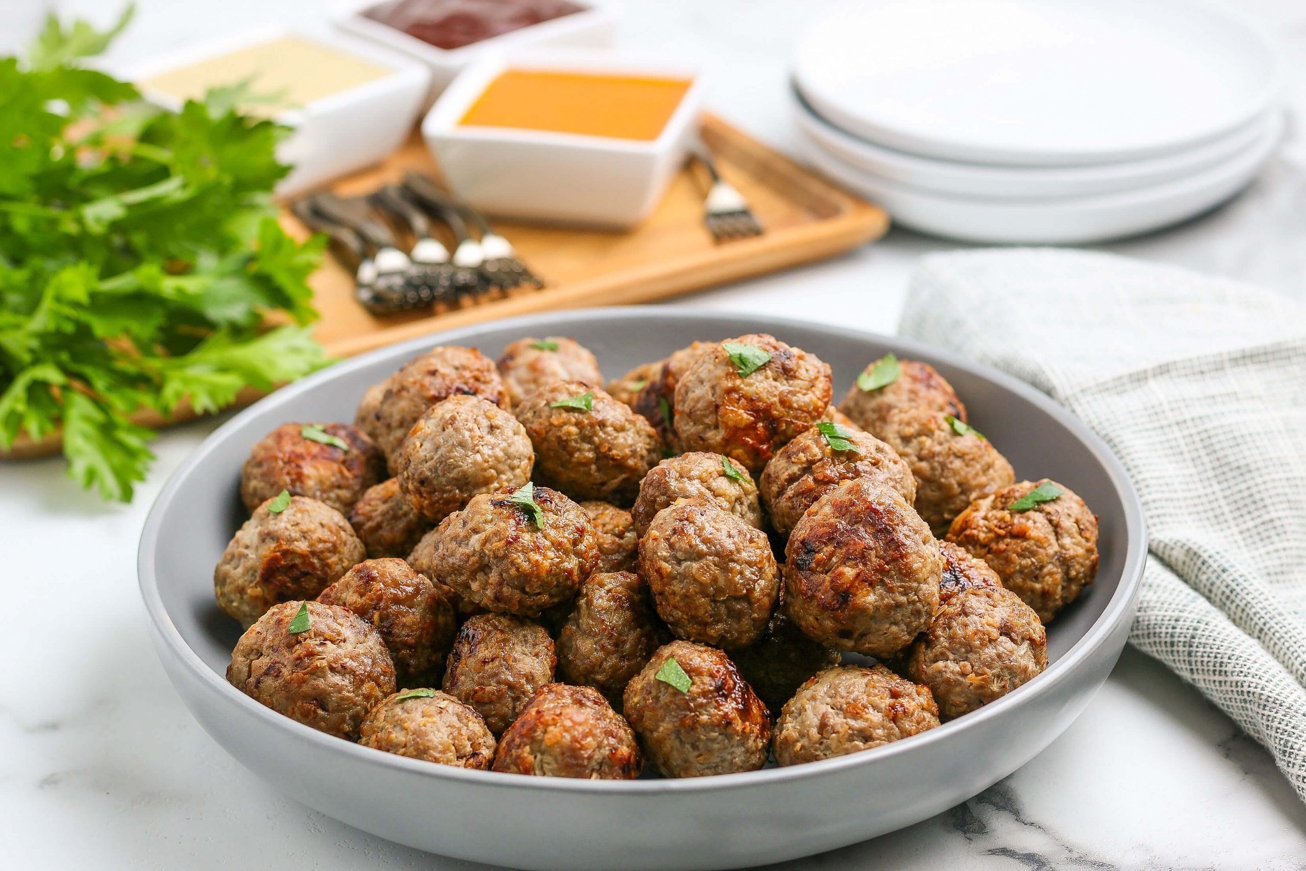 Air fryer meatballs recipe takes all of the work out of making homemade meatballs. In minutes, your family can enjoy the best flavor packed meatballs. Enjoy this easy beef and turkey recipe on subs, spaghetti and more. #eatingonadime #airfryermeatballs