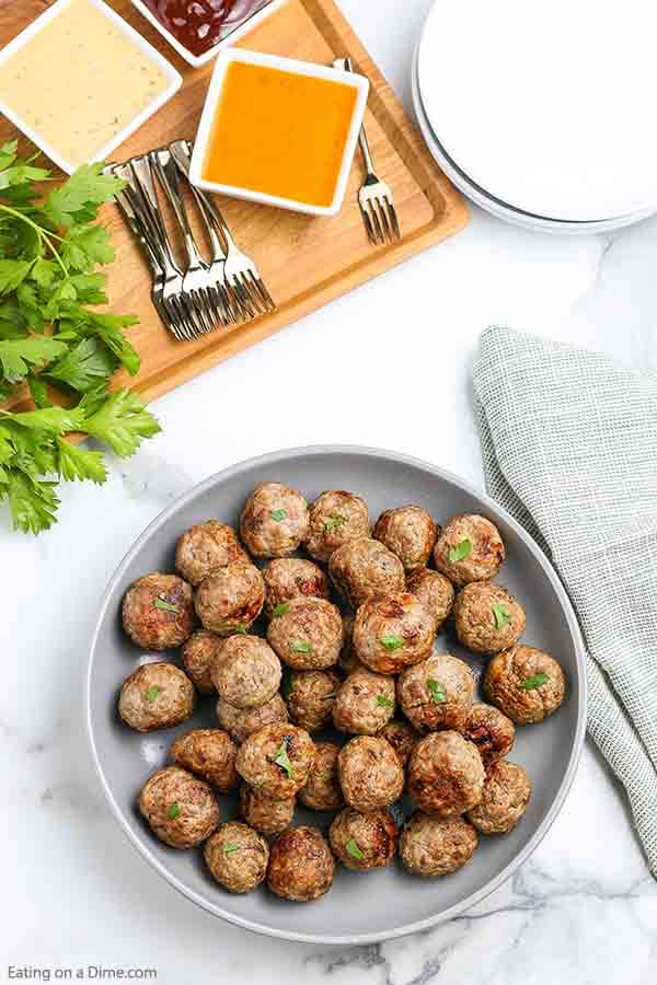 Air fryer meatballs recipe takes all of the work out of making homemade meatballs. In minutes, your family can enjoy the best flavor packed meatballs. Enjoy this easy beef and turkey recipe on subs, spaghetti and more. #eatingonadime #airfryermeatballs