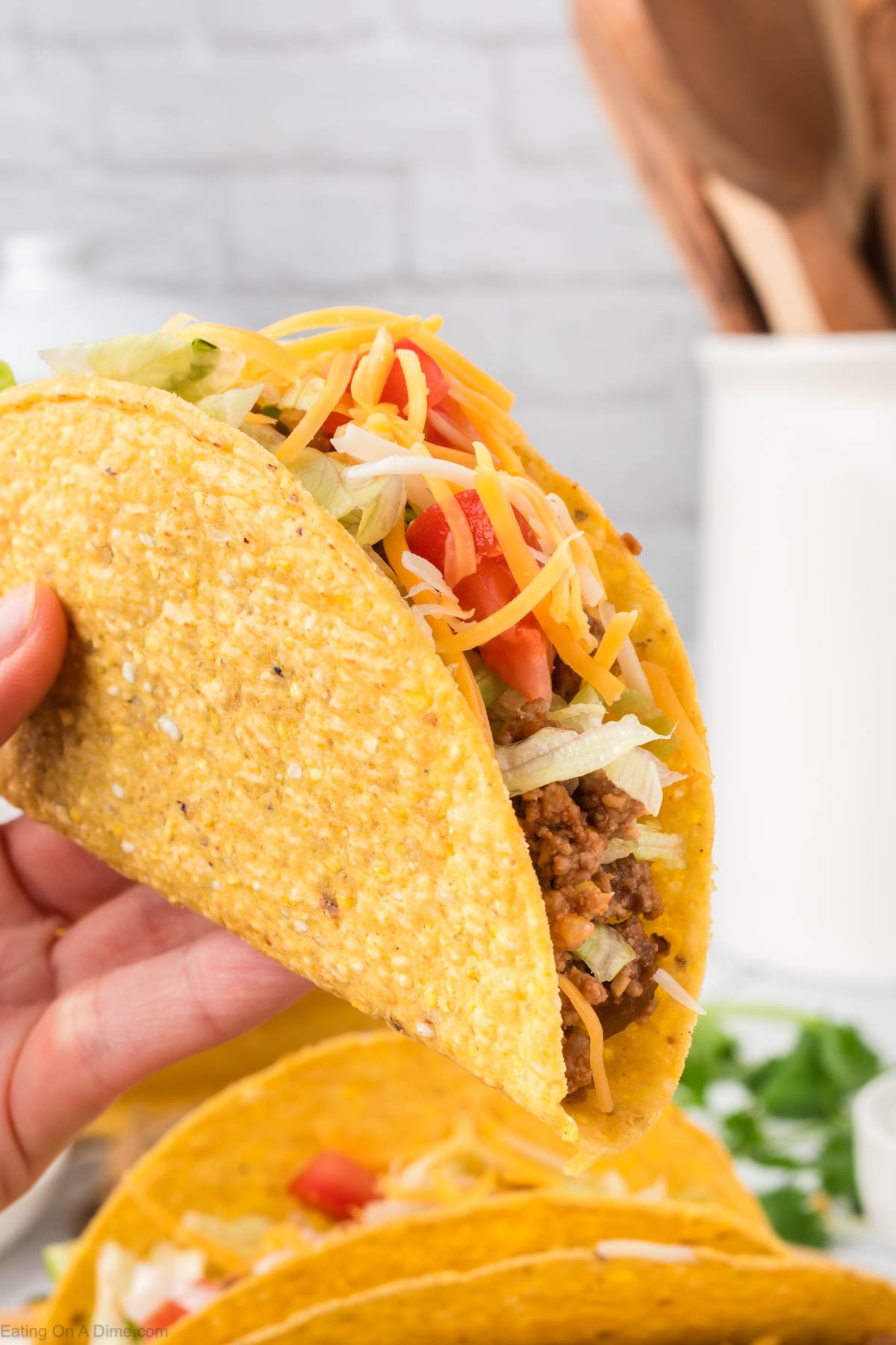 Ground beef tacos being held close up