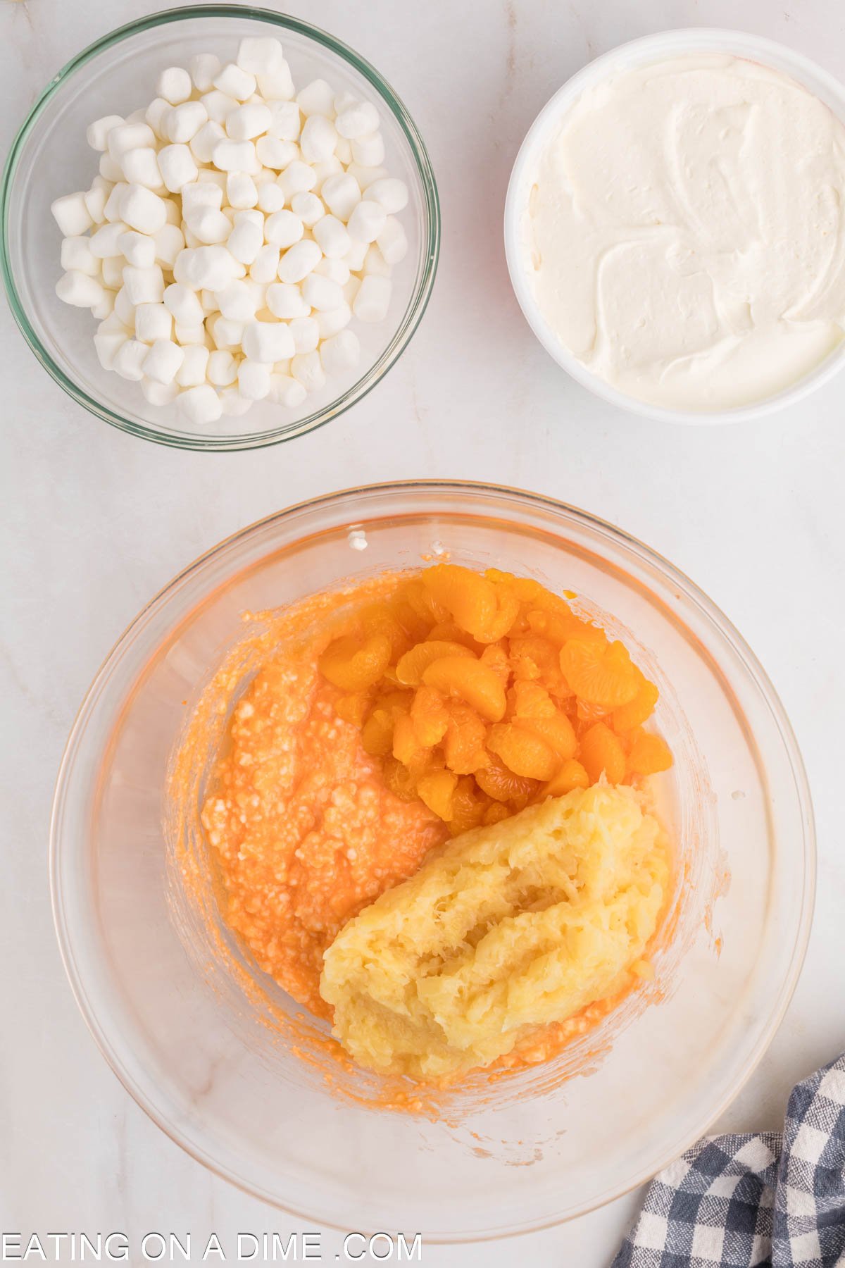 Adding the oranges and pineapple to the cottage cheese mixture