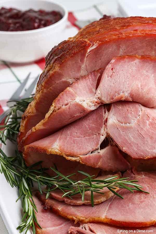 We are going to show you how to cook spiral ham that has the absolute best glaze. This easy ham recipe is tender and delicious for a great meal idea! Make this spiral ham in oven at Christmas, Easter and more. Each bite of this glazed baked ham is juicy and tender. #eatingonadime #spiralhamrecipe #ovenhowtocook #inovenbrownsugar
