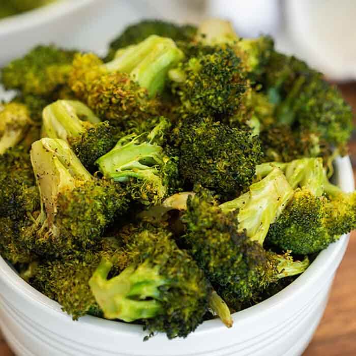 Try this recipe for air fryer broccoli in minutes. Each bite is crispy and tasty with amazing garlic flavor for the best side dish. Try this healthy and keto recipe for fresh broccoli. #eatingonadime #airfryerbroccoli #recipesfresh
