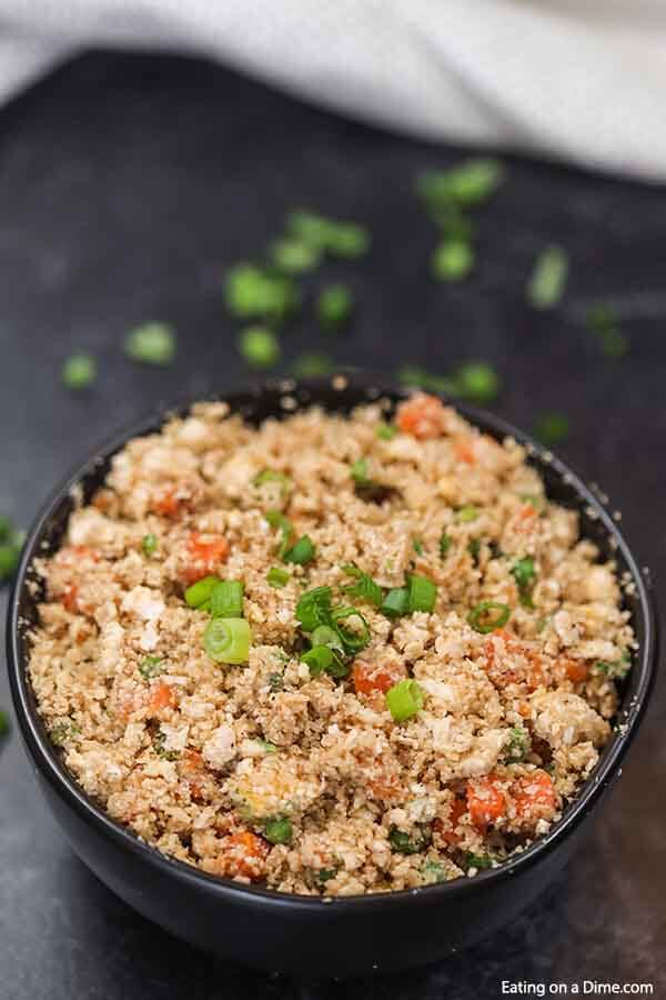 Skip takeout and enjoy this easy Cauliflower fried rice recipe at home. This delicious recipe is keto friendly while being packed with flavor. Learn how to make the best keto low carb cauliflower fried rice with egg. #eatingonadime #cauliflowerfriedricerecipe #whole30 #RecipesEasy #RecipesHealthy #KetoEasy #healthy #recipes