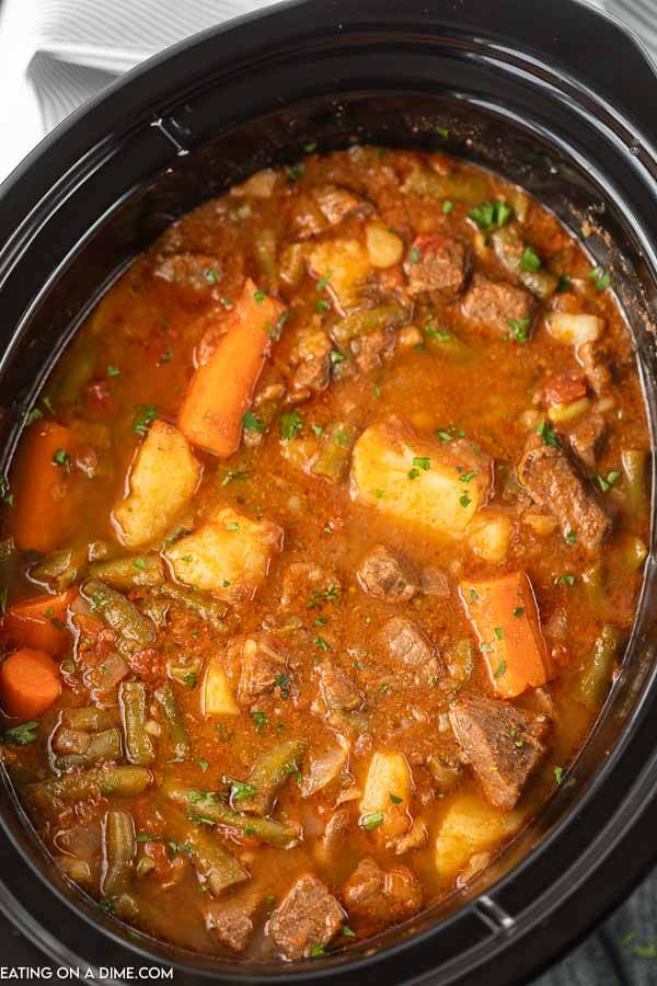 This crock pot beef stew recipe is easy to make with no browning needed! You are going to love this quick and easy slow cooker beef stew. Close up image of beef stew in crock pot.