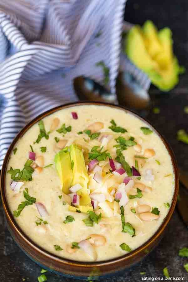 Crock pot green enchilada chicken soup is so creamy. The cheese and green enchilada sauce create a rich and creamy soup with hearty chicken. Green Enchilada Chicken Soup is the best recipe and healthy. Try this easy slow cooker soup. #eatingonadime #greenchickenenchiladasoup #crockpot 