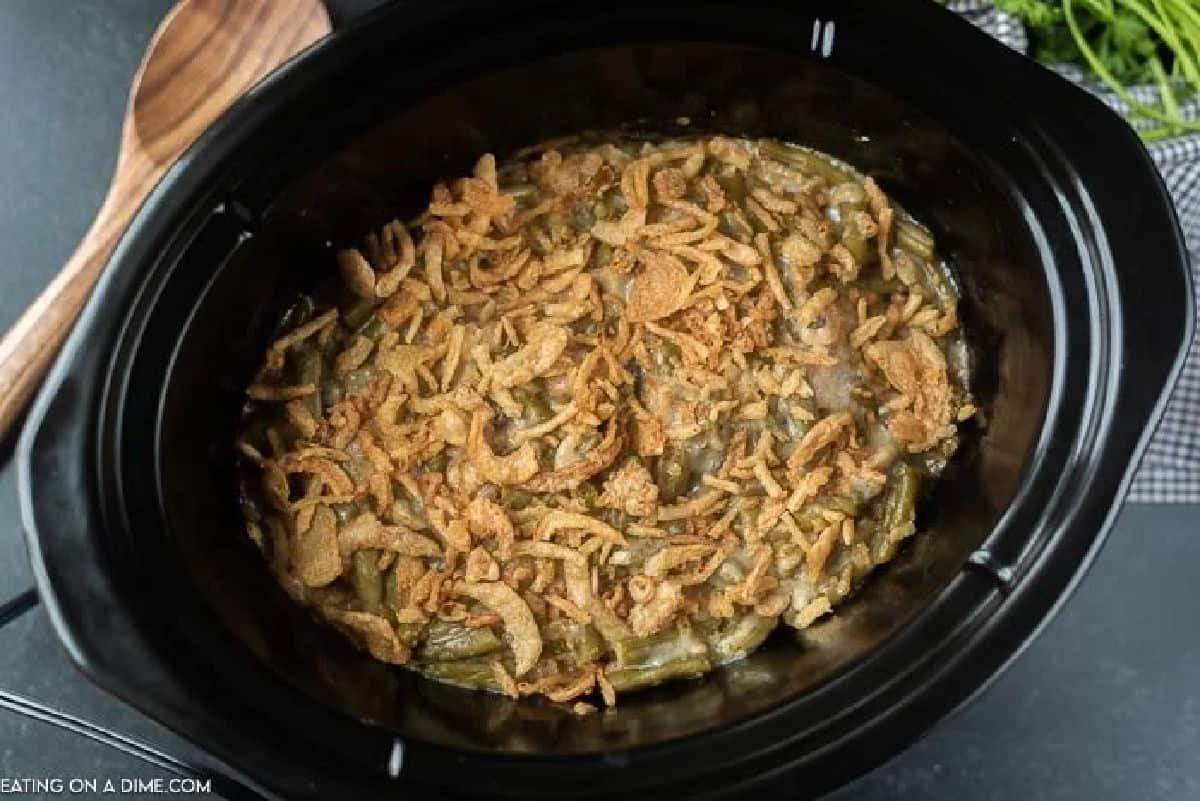 Free up the oven this holiday season with this Crock pot Green Bean Casserole Recipe! It turns out amazing and is one less dish to worry about! Overview of green bean casserole in the crock pot.