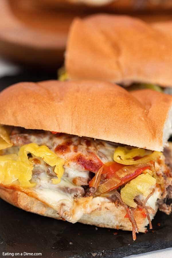 The pressure cooker makes homemade Italian beef sandwiches quick and easy with chuck roast. The beef is so tender and the hot peppers make this instant pot recipe flavorful and authentic. Learn how to make the best shredded Chicago style sandwiches in the insta pot. #eatingonadime #instantpotitalianbeefsandwiches #chicago #instapot