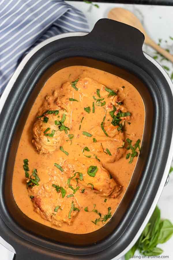 Slow cooker tomato basil chicken recipe is so creamy with the best tomato sauce. The crock pot makes it easy. Crock Pot Tomato Basil Chicken is great with rice or pasta. Everyone will go crazy over Slow Cooker Tomato Basil Chicken recipe. #eatingonadime #tomatobasilchicken #slowcooker #slowcookercreamy