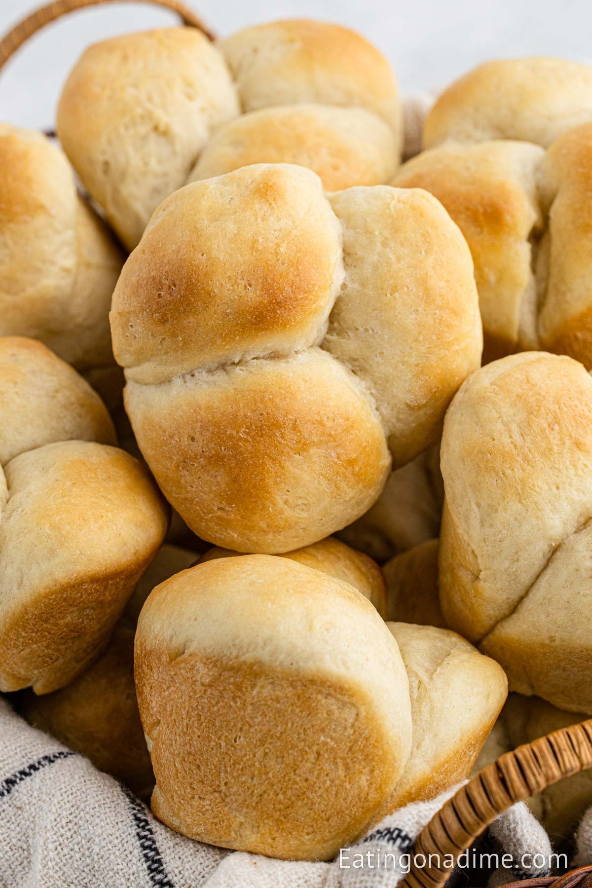 Homemade Dinner Rolls stacked in a basket. 