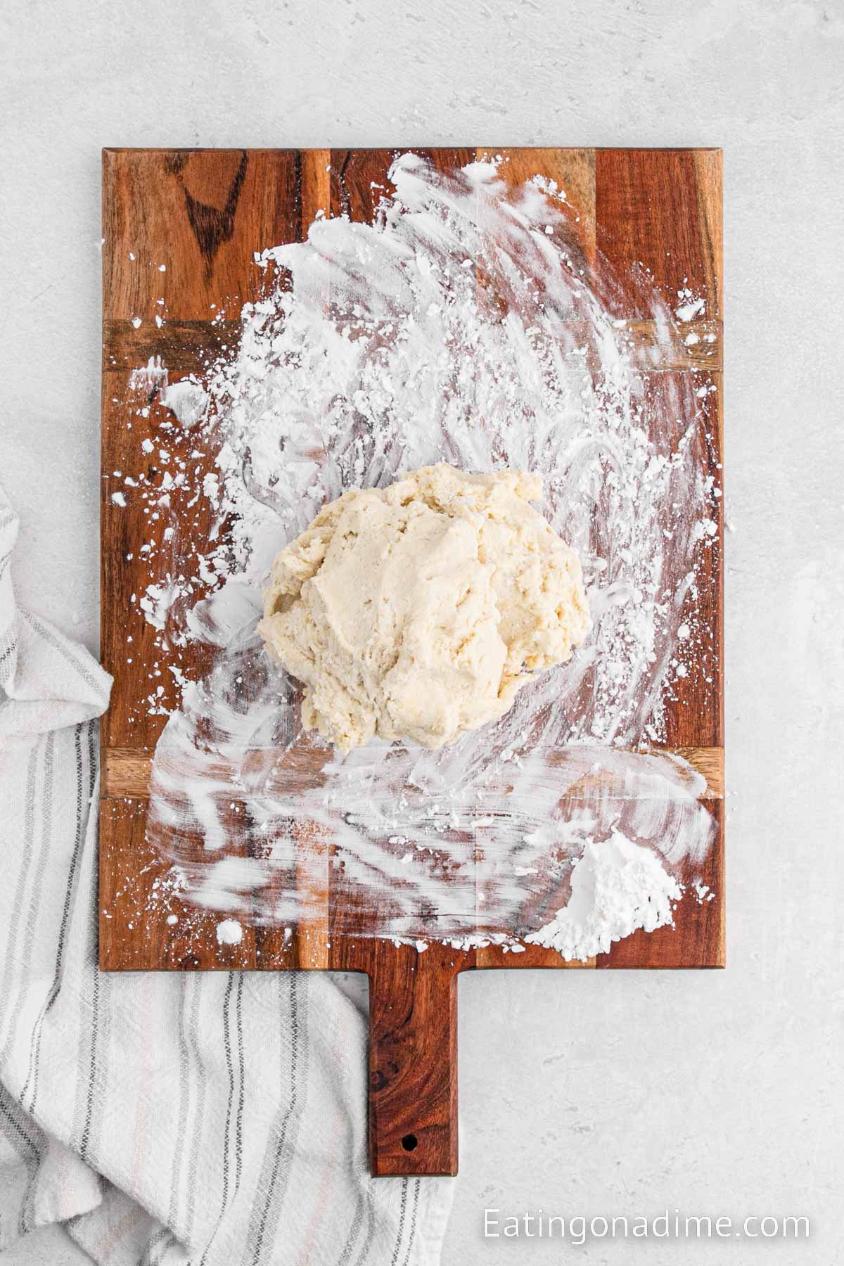 Placing the biscuit dough on a floured surface