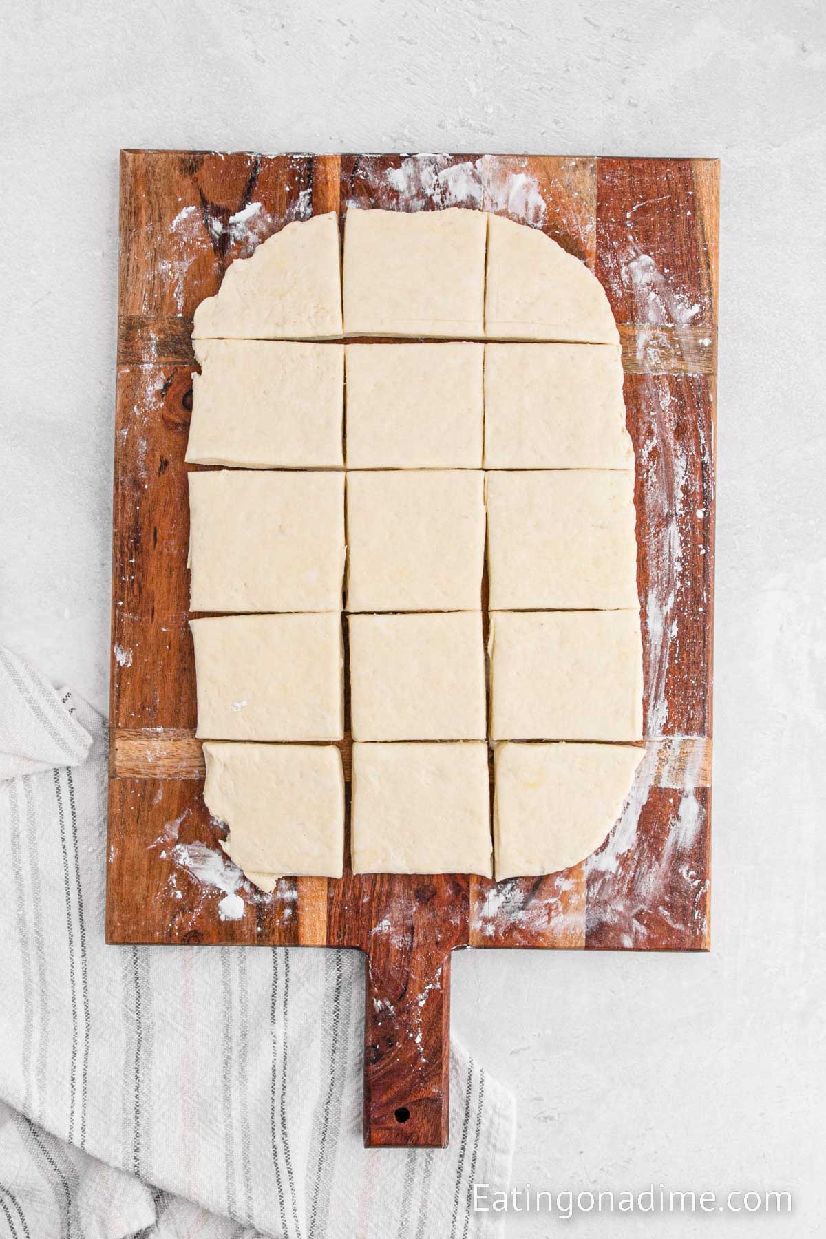 Biscuit dough cut into pieces on a cutting board