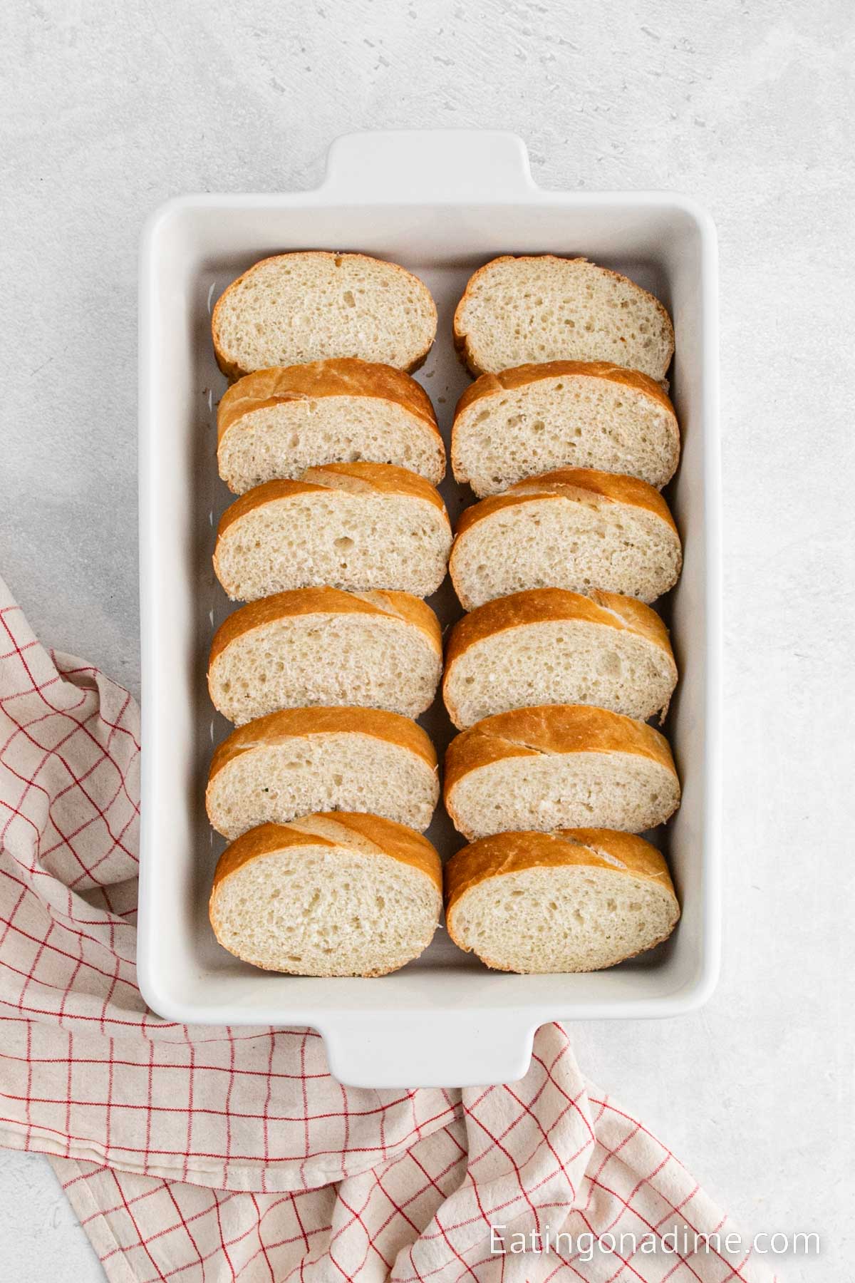 Slice bread in a casserole dish