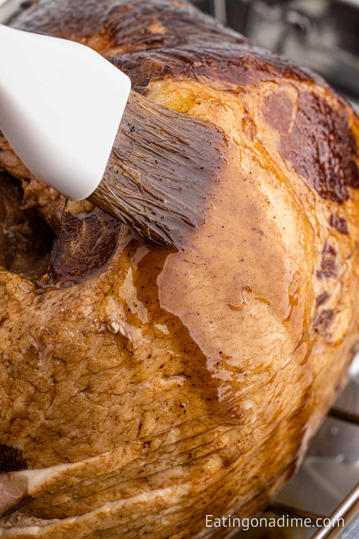 Brushing the glaze on the ham