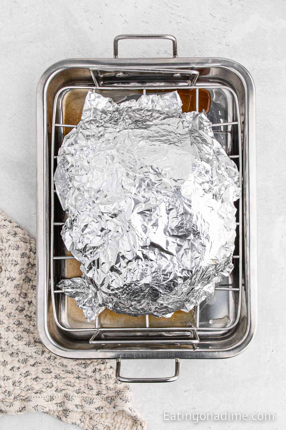 Covering the ham with foil in a roasting pan