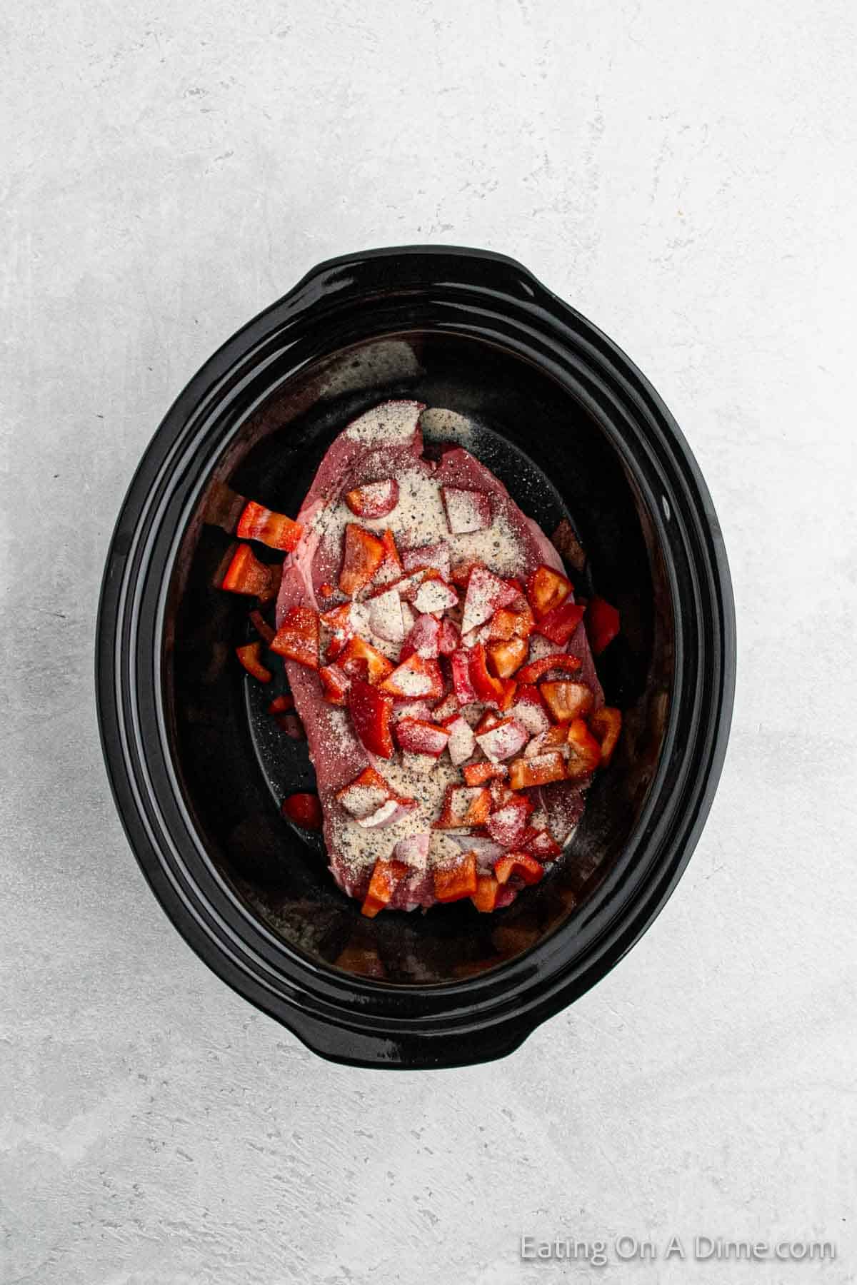 Place the roast in the slow cooker topped with seasoning packet and red bell pepper