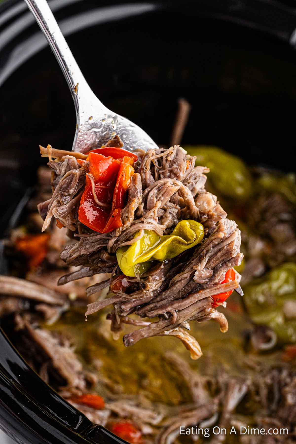 Close up image of shredded beef and a serving on a fork