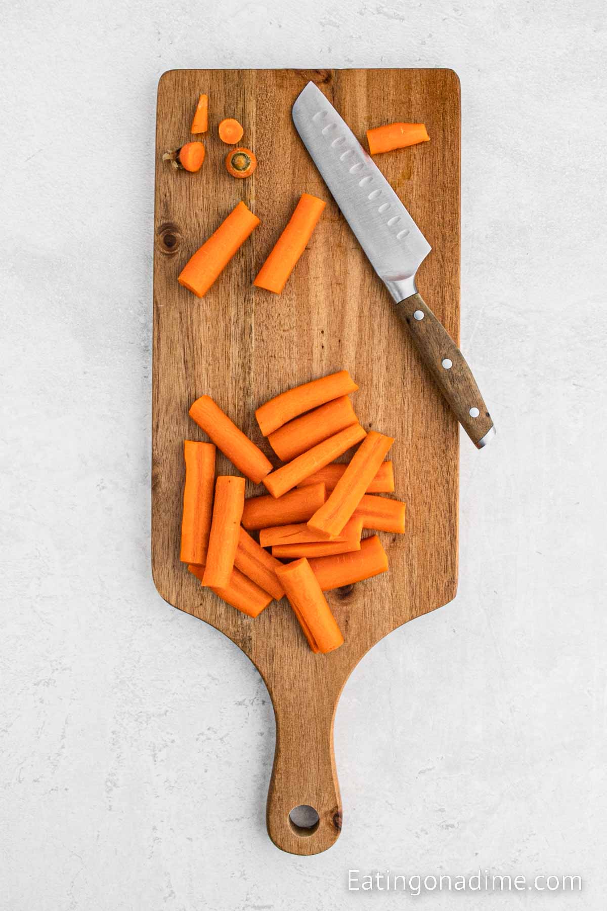 Cut the carrots on the cutting board with a knife