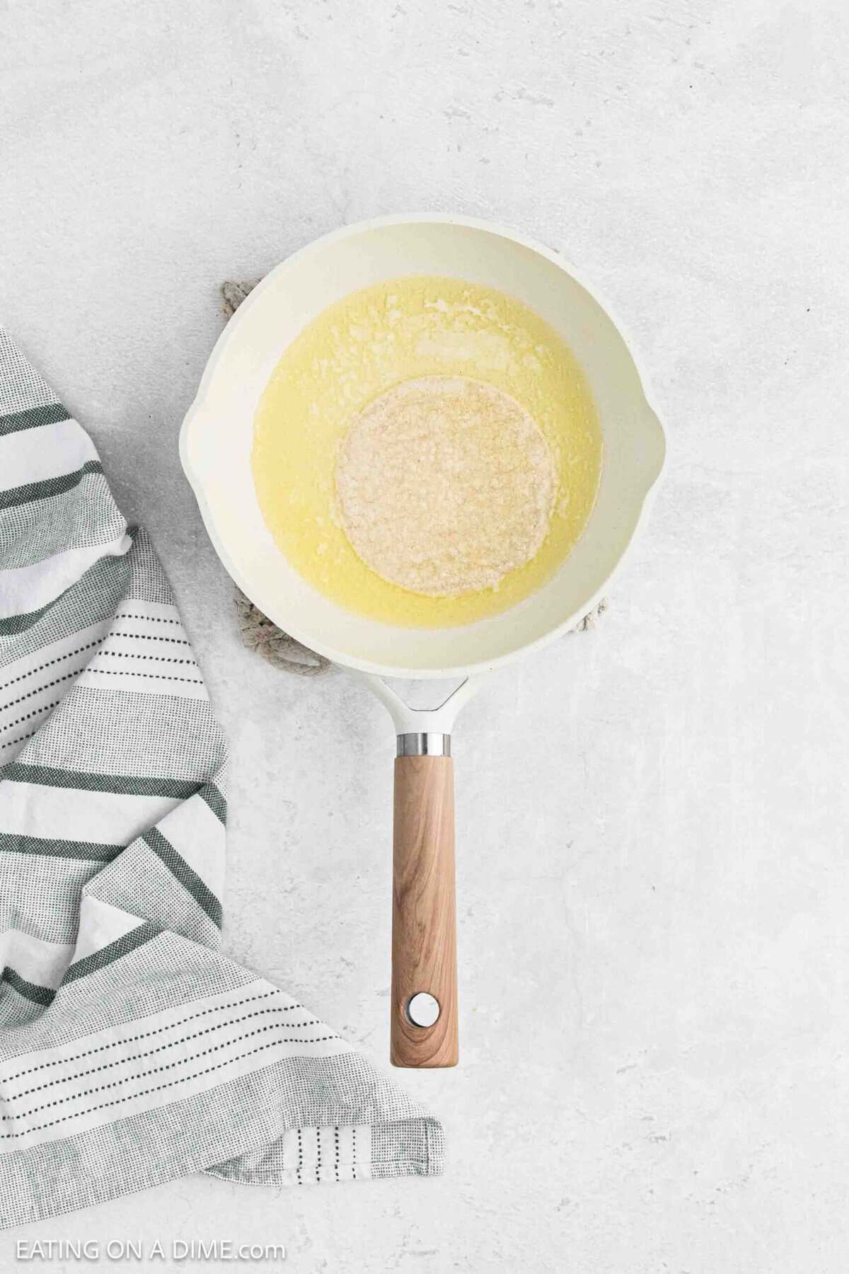 Melted butter and a small tortilla in a small skillet.