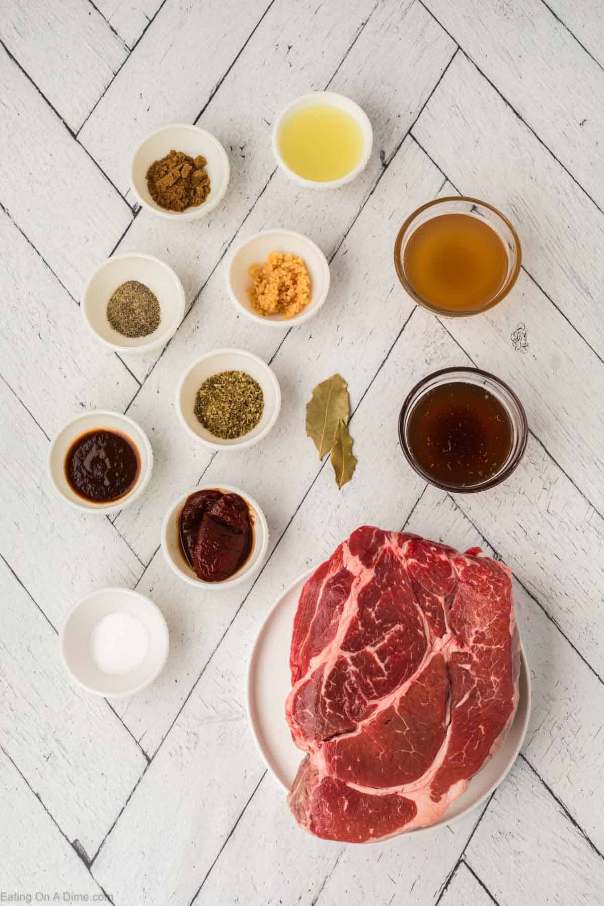 Roast, chipotle peppers, adobo sauce, minced garlic, apple cider vinegar, cumin, oregano, salt, pepper, limes, beef broth, bay leaves