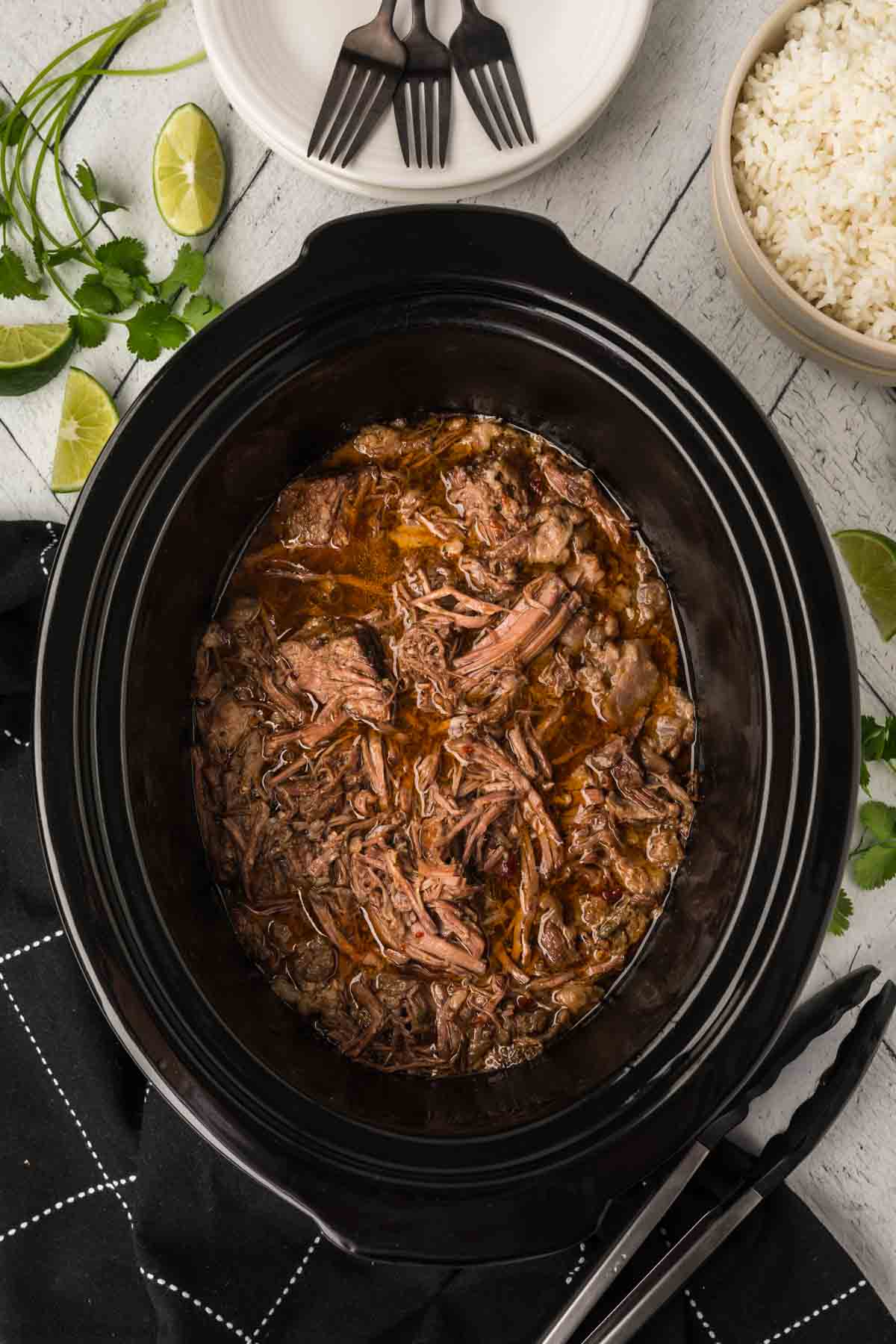 Shredded beef in the sauce and seasoning in the slow cooker