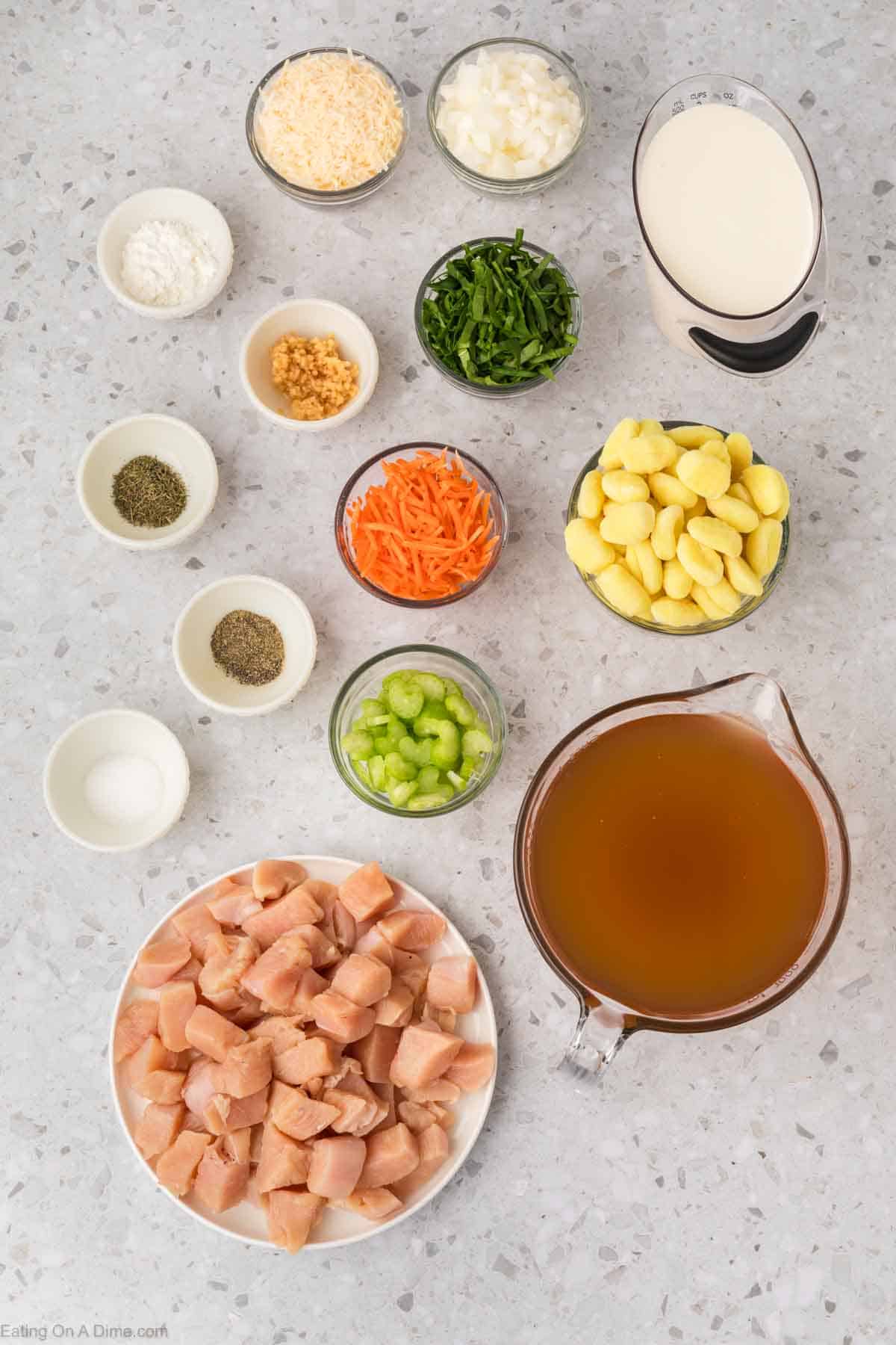 Olive Garden Chicken Gnocchi Soup ingredients - chicken, celery, onion, minced garlic, carrots, chicken broth, salt, pepper, potato gnocchi, heavy cream, corn starch, baby spinach, parmesan cheese