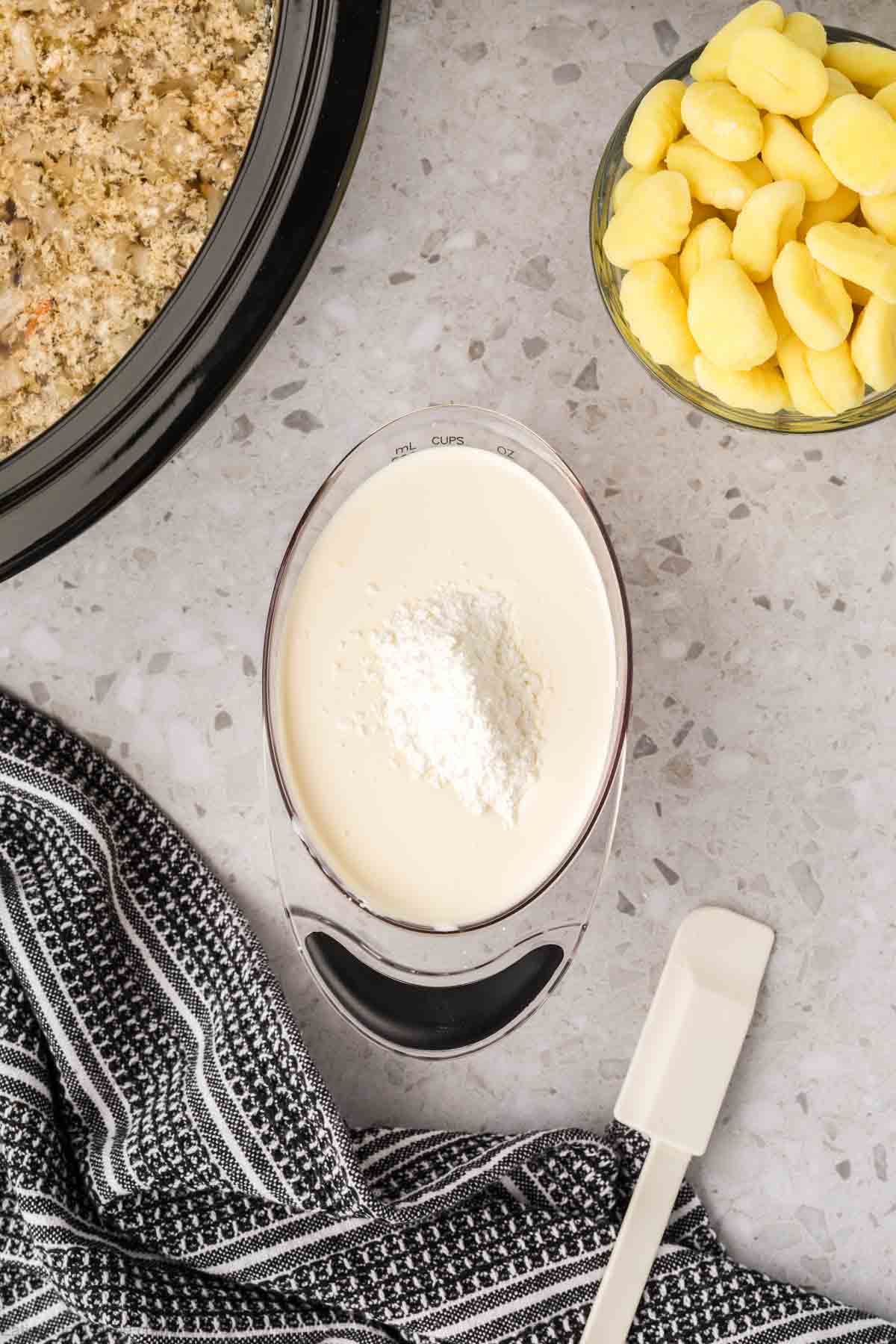 Mixing heavy cream and cornstarch together in a bowl