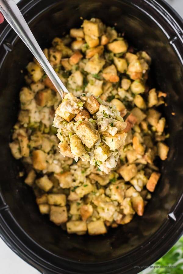 Stuffing in the crock pot with a serving on a spoon
