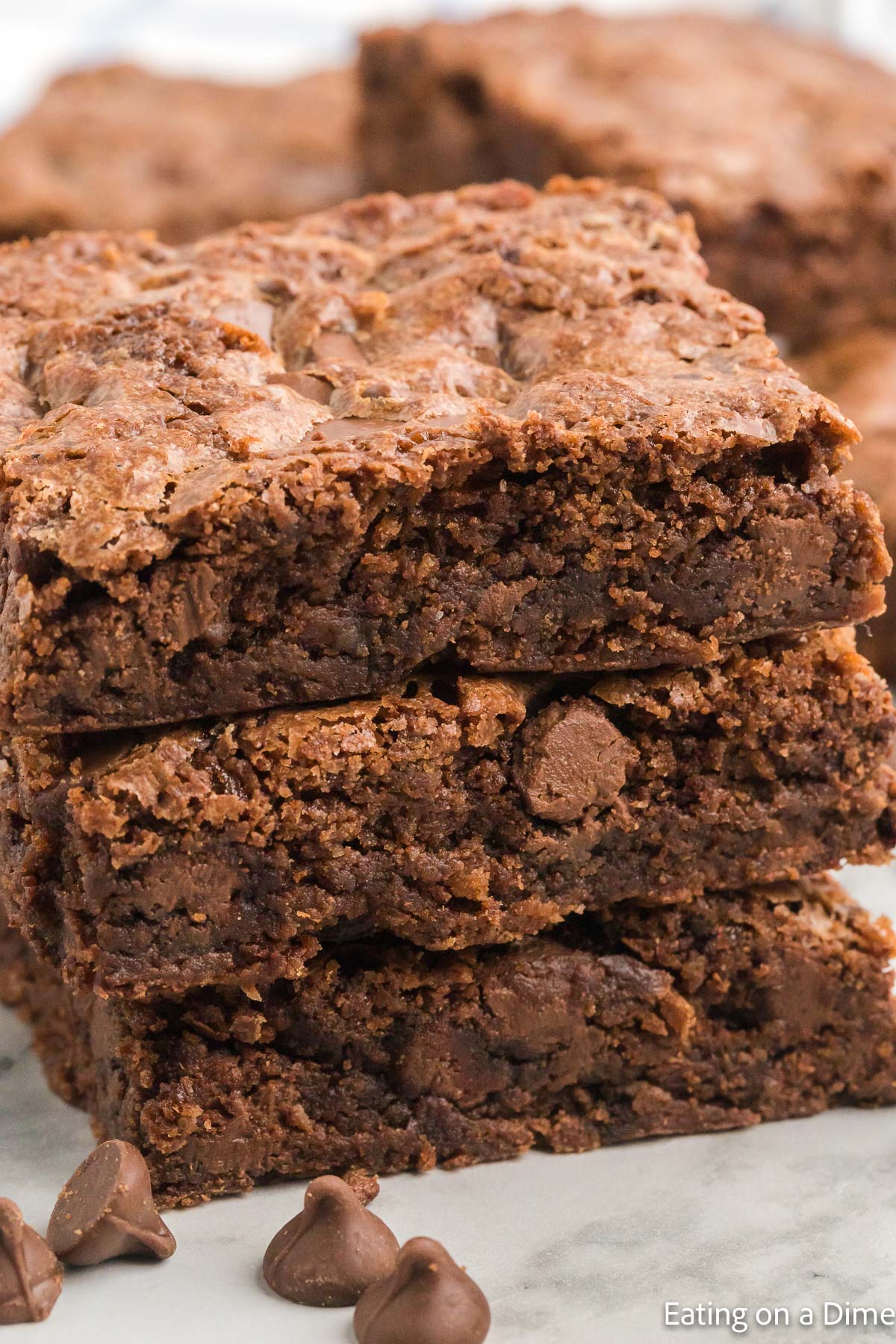 Everyone will love these decadent Double chocolate chip brownies. Each bite is loaded with tons of chocolate and the entire recipe is so easy. Chocolate Chip Brownies cut into squares stacked