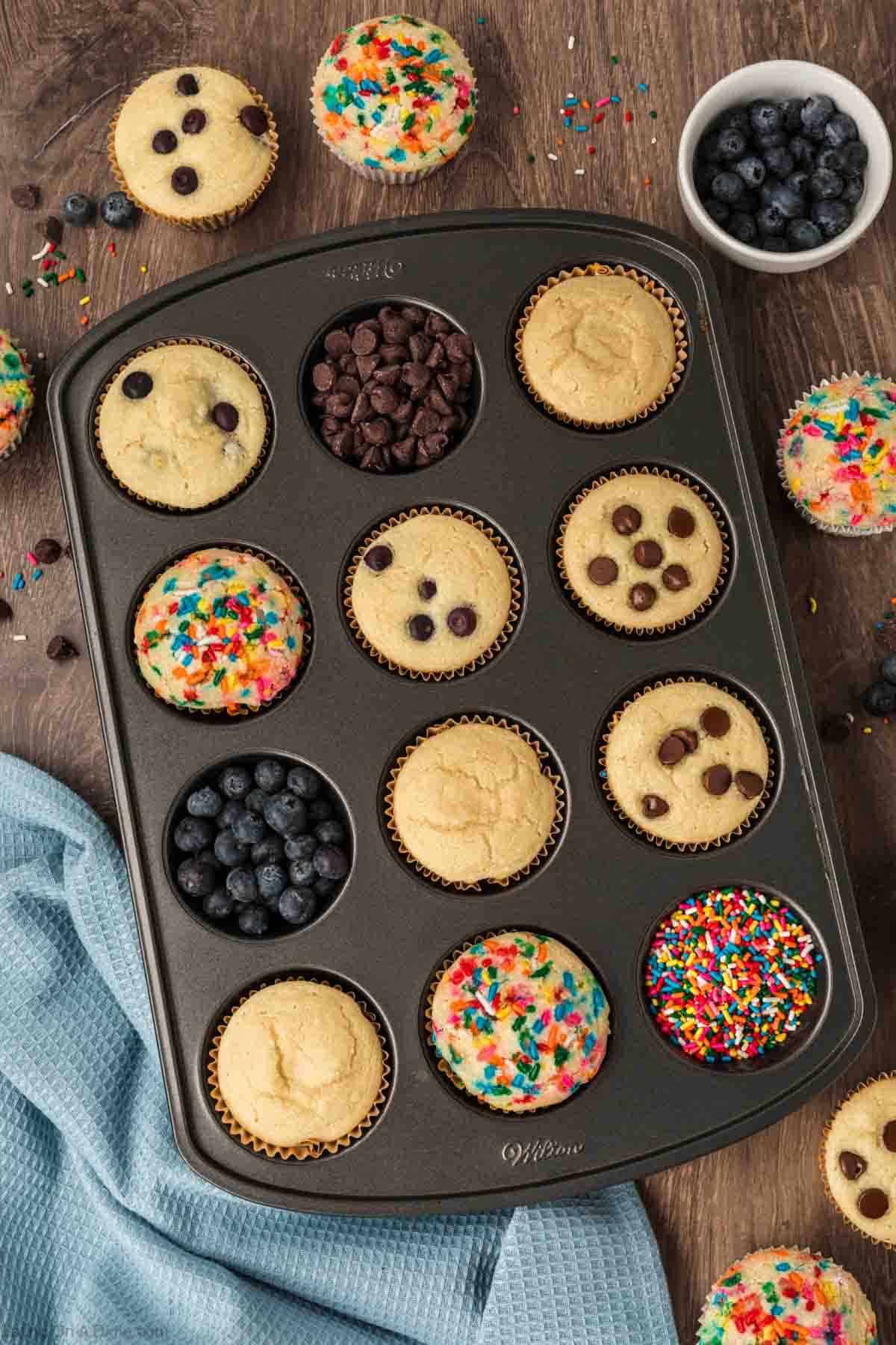 Pancake Muffins in a muffin tins topped with chocolate chips and sprinkles
