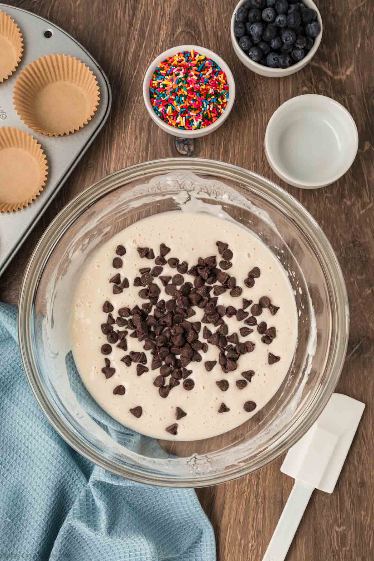 A bowl of pancake mix topped with chocolate chips