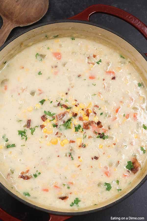 Corn chowder recipe is easy to make with creamed corn, potatoes and delicious seasonings. You can make this cream soup on the stove top in 30 minutes. Learn how to make this simple and healthy potato and corn soup. Top with bacon and cheddar! #eatingonadime #cornchowderrecipe #easyfast #soupeasy #baconpotato #cheesy #vegetarian 