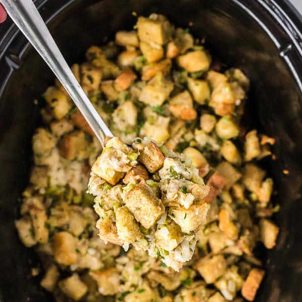 Stuffing in a slow cooker with a serving on a spoon