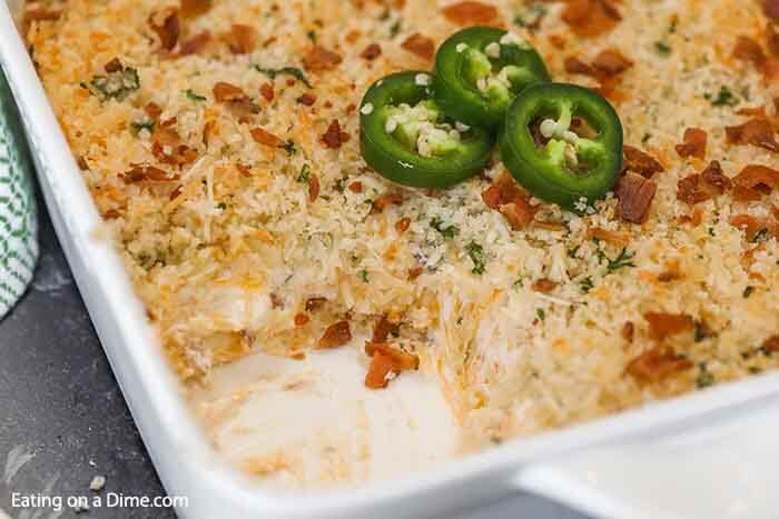 Step up your appetizer game with this easy Jalapeno popper dip recipe. The entire dish is creamy with the perfect amount of heat and topped with panko and bacon. Jalapeno Popper Dip Recipe is the best hot dip and so cheesy. Everyone will love the delicious blend of cheesy bacon, cream cheese and jalapenos baked to perfection. Serve this simple appetizer warm and enjoy! #eatingonadime #jalapenopopperdiprecipe #easycreamcheeses #appetizers #jalapenopopperdippingsauce