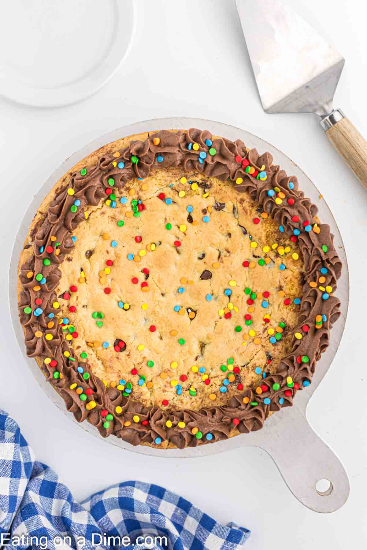 Cake mix cookie cake decorated with chocolate frosting and sprinkles
