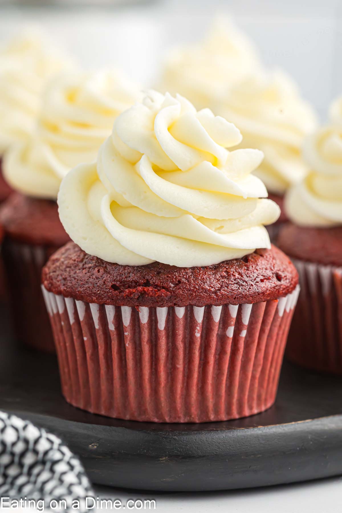 Close up image of red velvet cupcakes frosted with cream cheese frosting