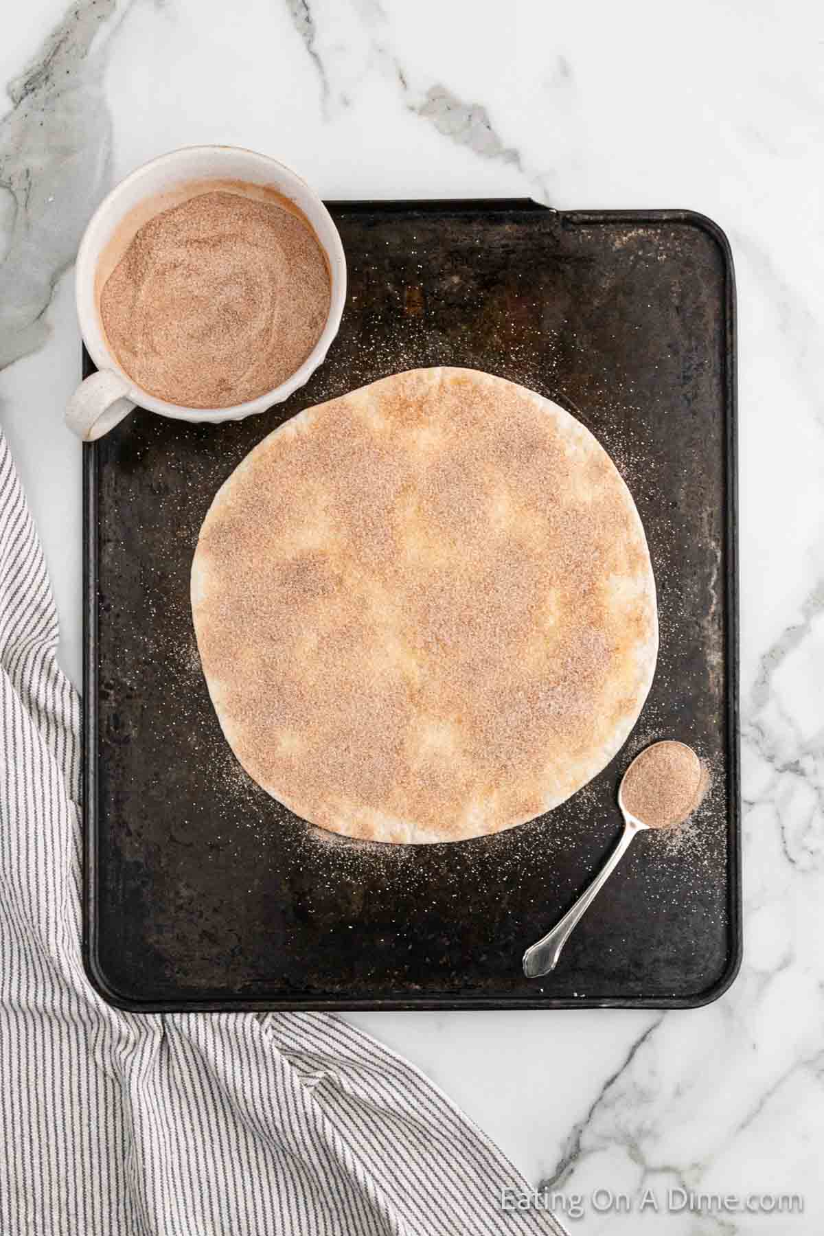 Tortilla topped with cinnamon and sugar mixture