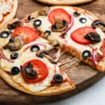 side view of pita pizza, sliced
