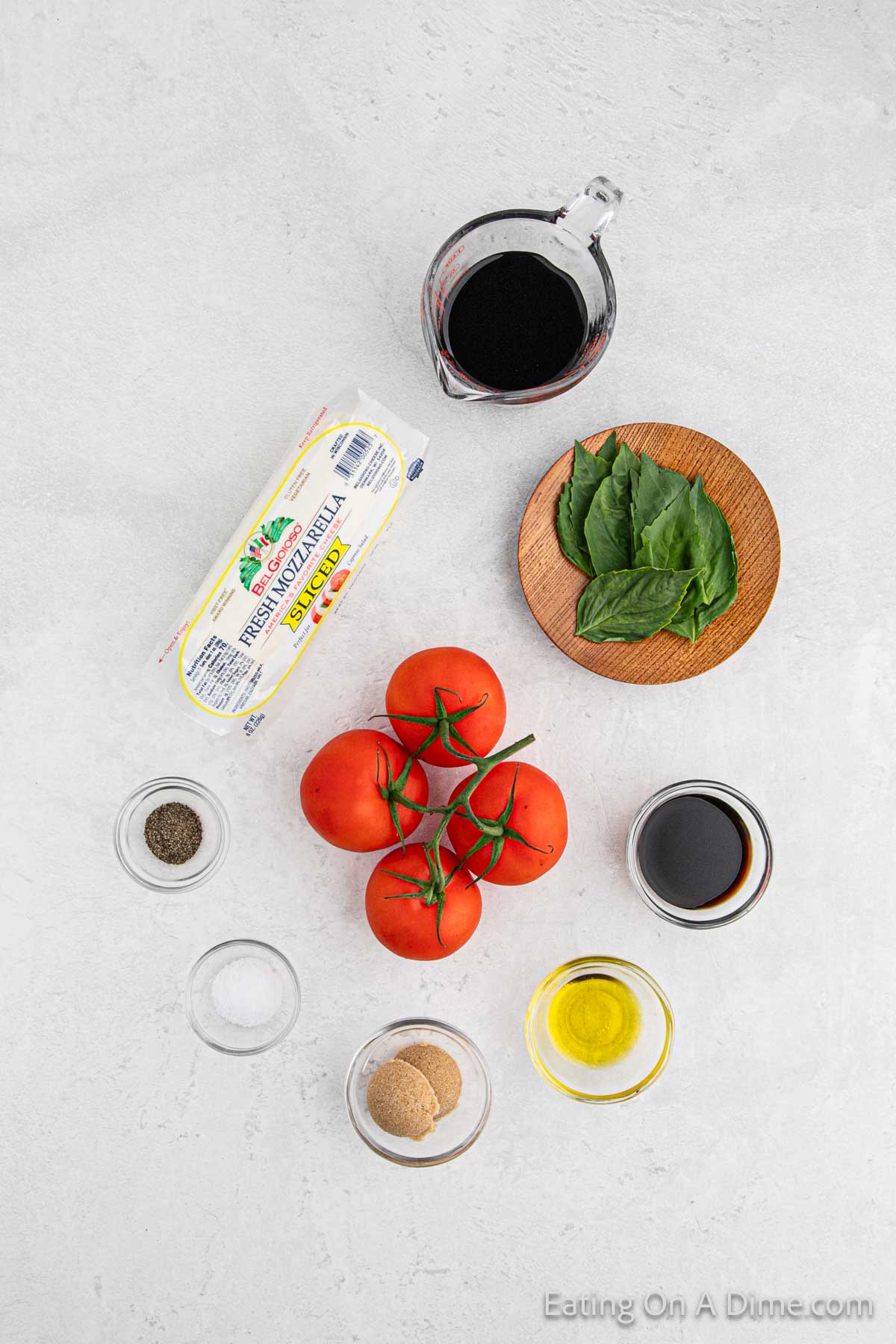 Ingredients for tomato mozzarella salad - vine tomatoes, fresh mozzarella, balsamic vinegar, basil, sea salt, pepper, balsamic vinegar, brown sugar