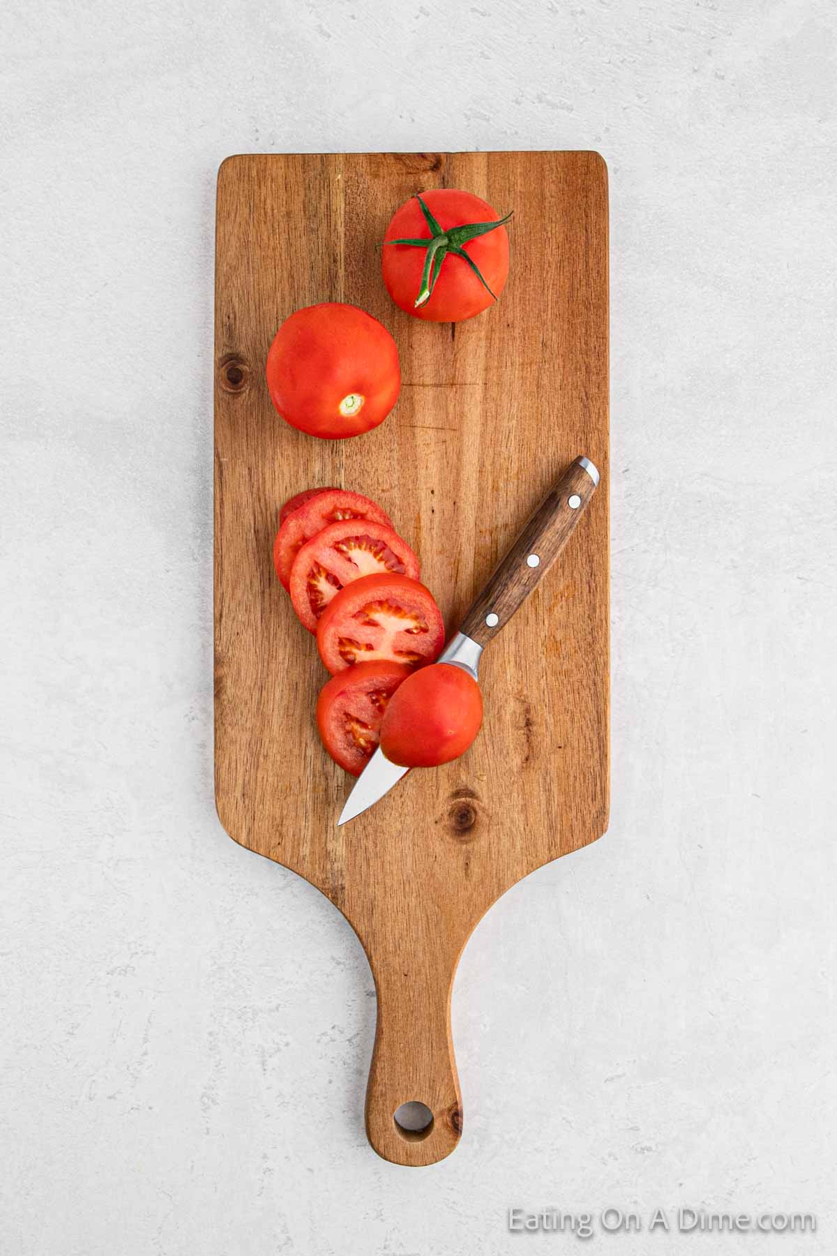 Slicing tomatoes on a cutting board