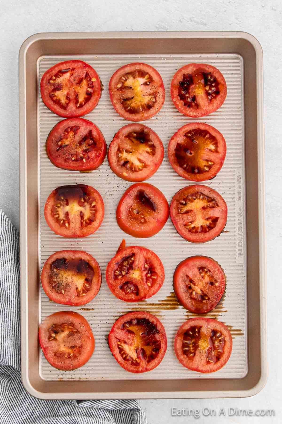Placing the slice tomatoes on a baking sheet