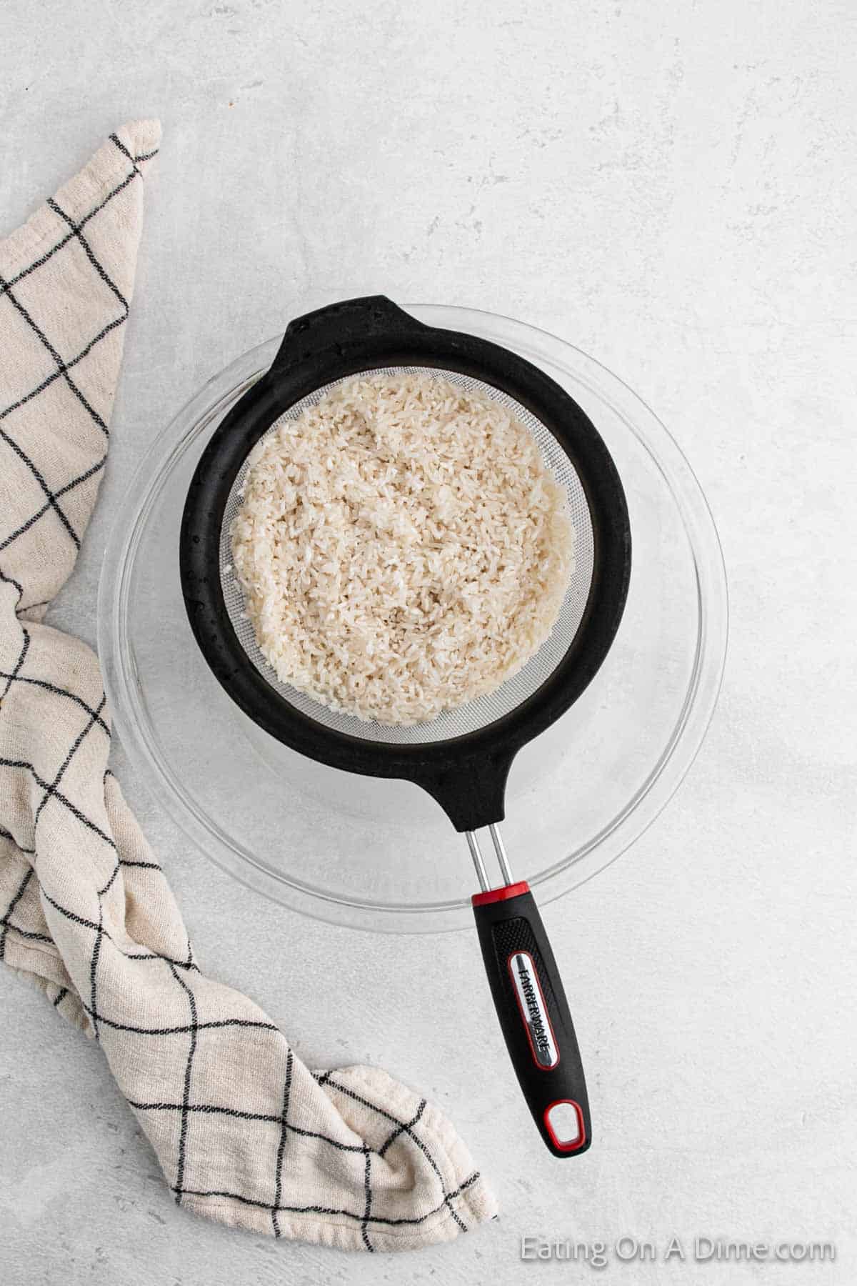 White Rice in a colander over a bowl