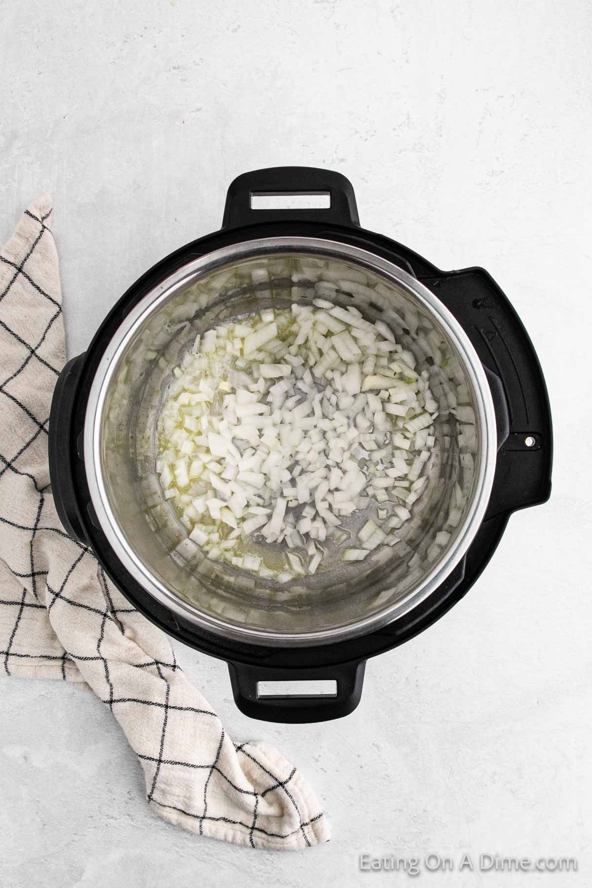 Chopped onions in the instant pot with melted butter