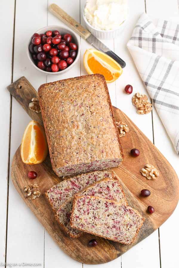 Cranberry orange bread recipe is a tangy and sweet quick bread that can be made with little effort. Your kitchen will smell amazing when you make this moist and easy fresh cranberry orange bread recipe. This is the best recipe for Christmas morning, holidays and more. #eatingonadime #cranberryorangebread #Recipeholidays #Desserts #cranberryorangebreadmoist