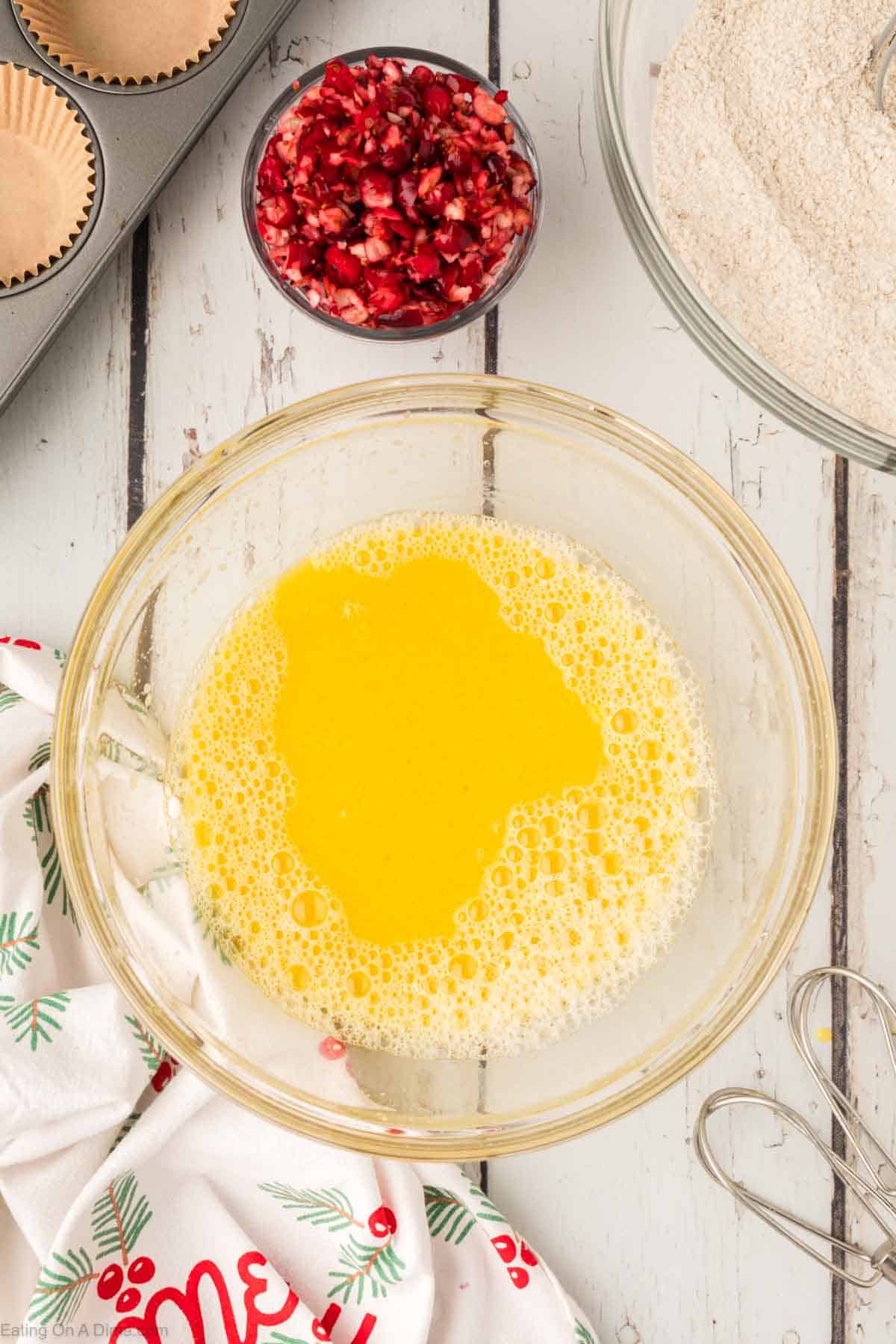 Beat eggs, orange juice and oil together in a bowl