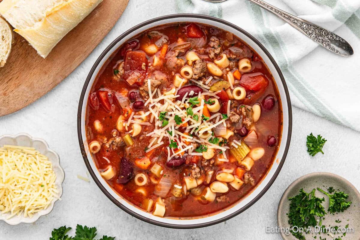 Pasta Fagioli in a bowl topped with shredded parmesan