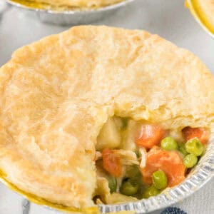 A small chicken pot pie with a bite taken out of it.