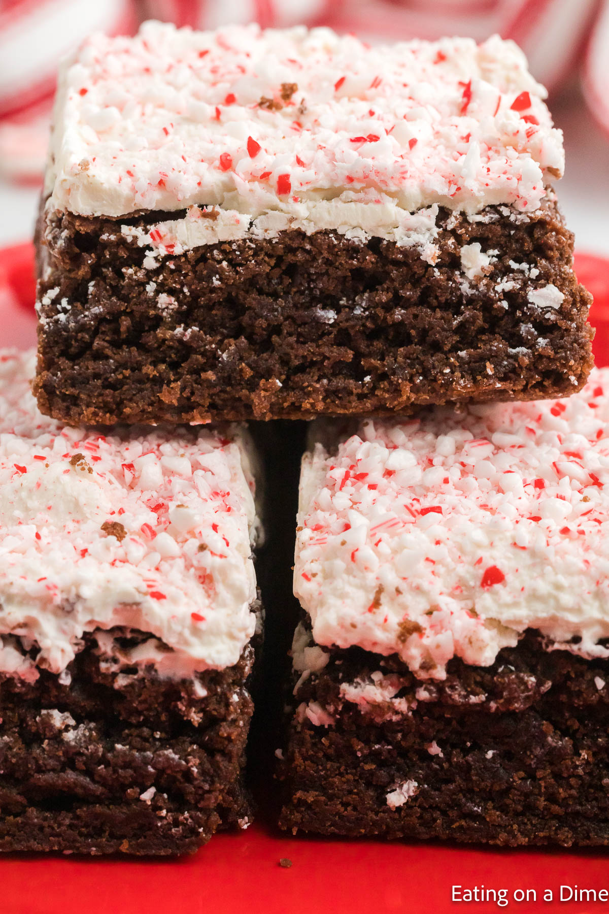 White chocolate peppermint brownies stacked on a plate